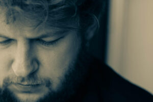 Man standing looking away feeling sad and depressed. Close up portrait