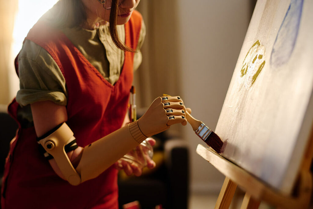 Female painting with a bionic hand