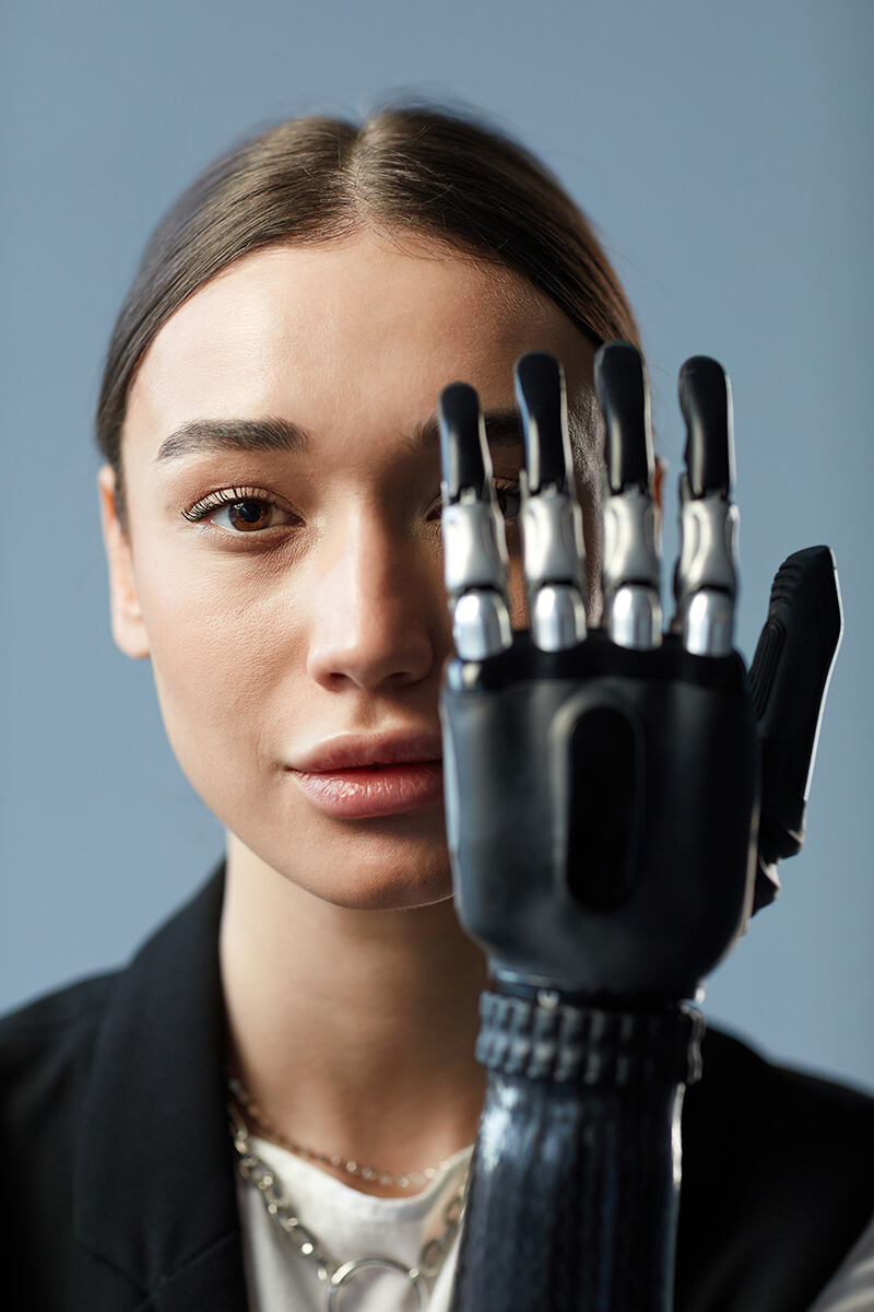 Woman in her 20s with an advanced robotic arm and hand