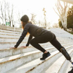Female amputee working out outdoors on the steps
