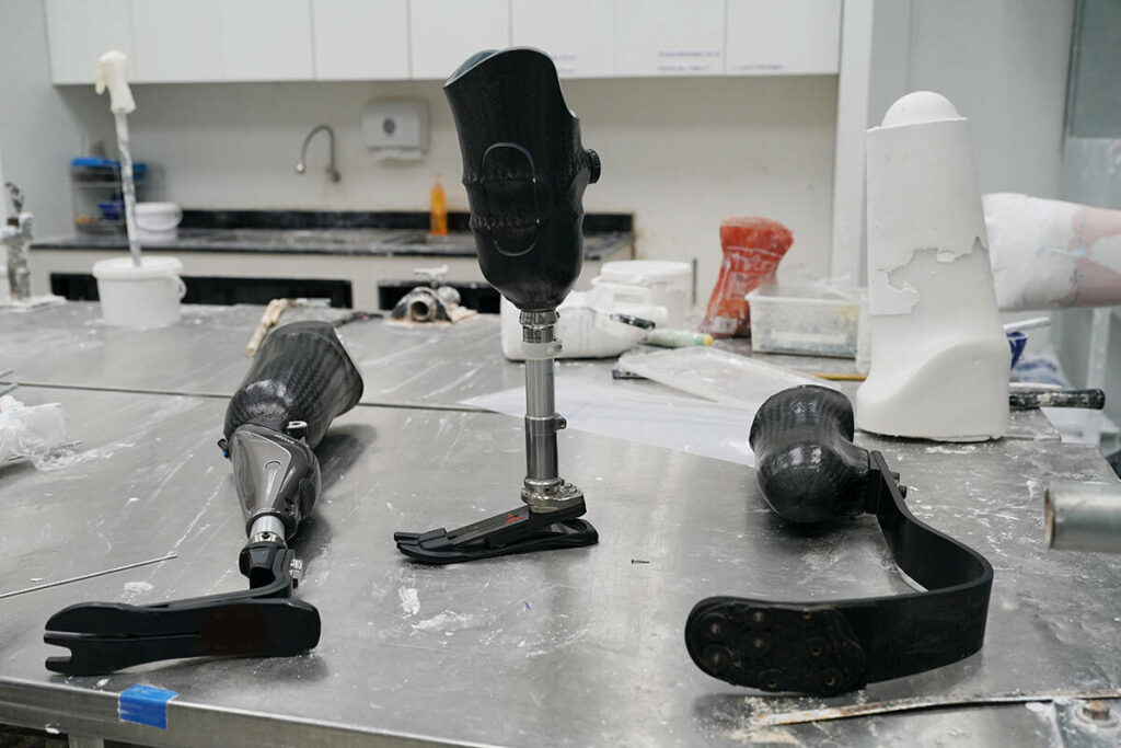 3 different prosthetic sockets with feet attached to them