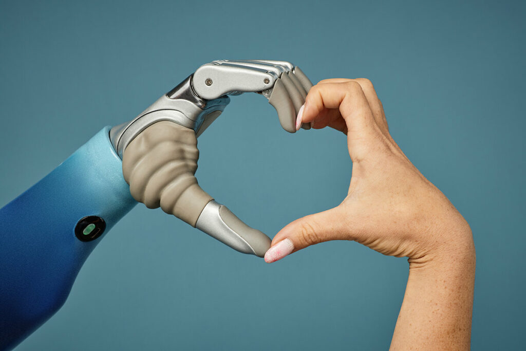 Female making a heart sign with a prosthetic hand