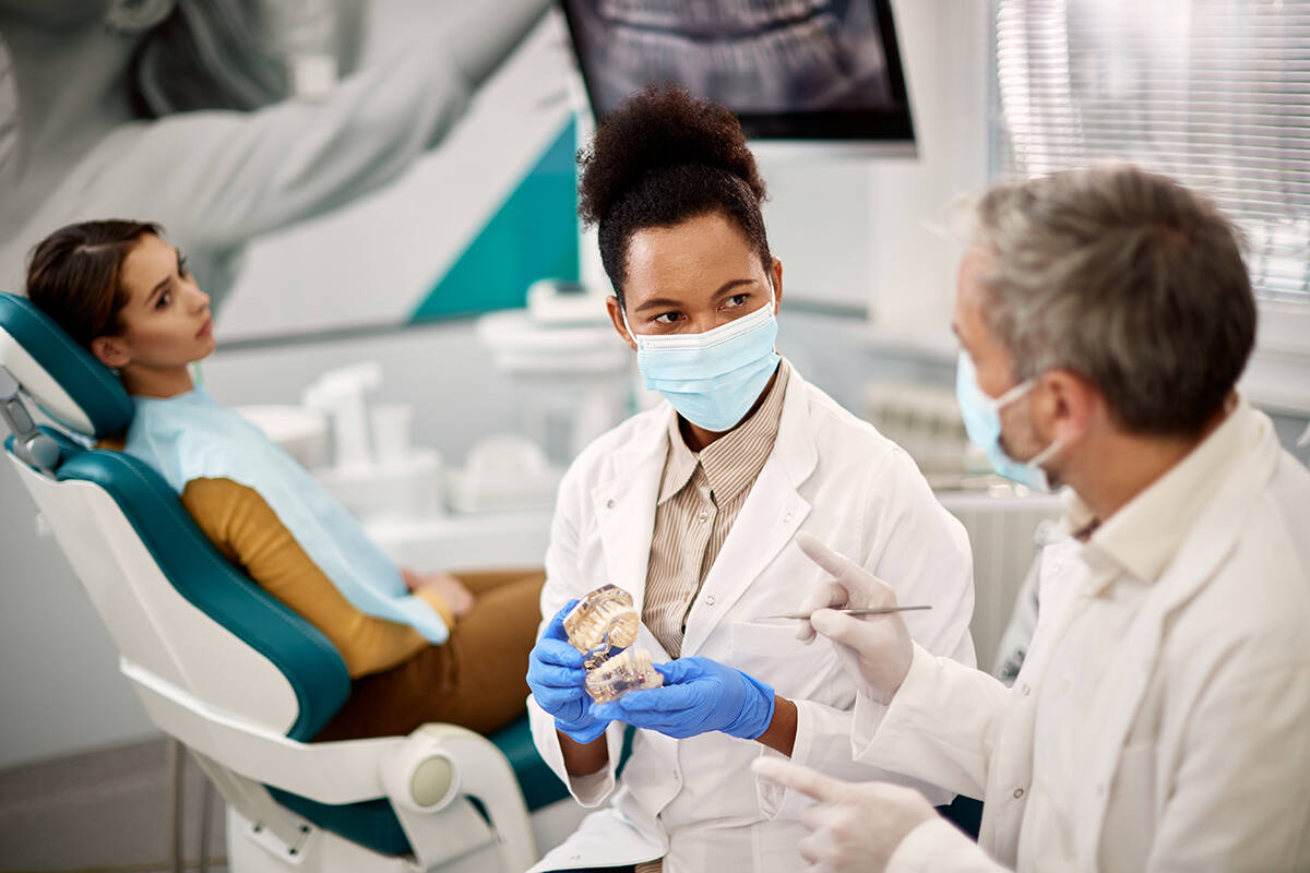 Two dentists having an discussion about prosthesis teeth
