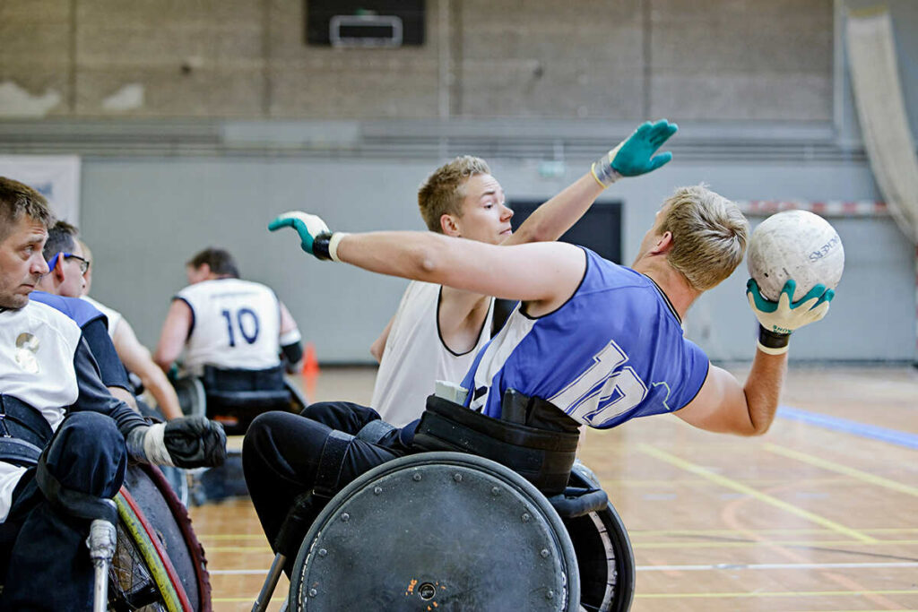 Group of amputees having a wheelchair basketball game