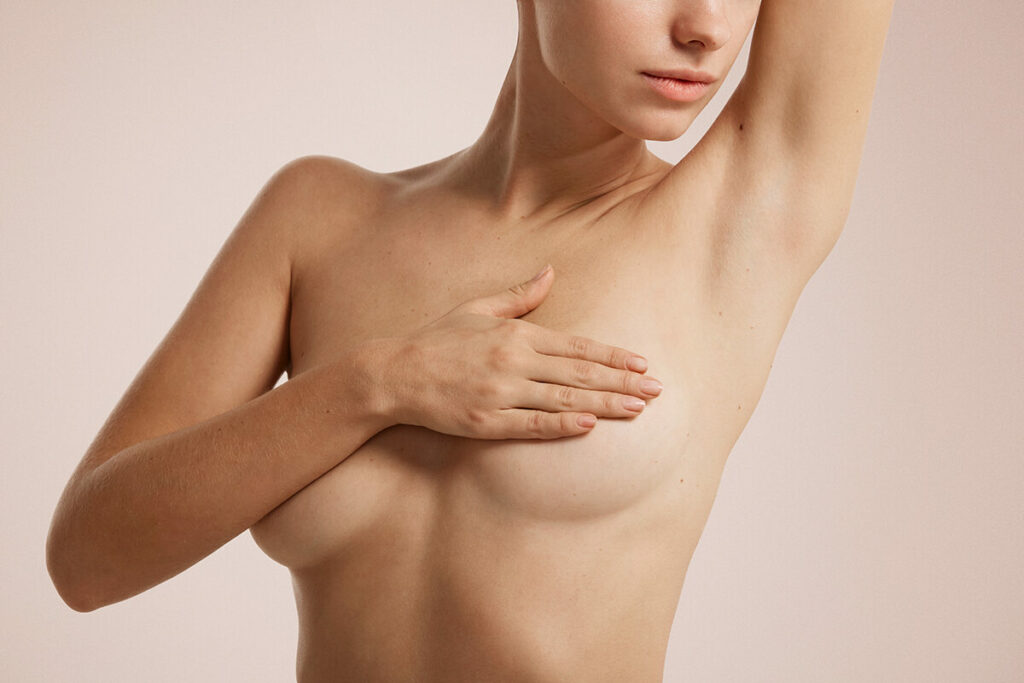 Female covering her breast with her right hand