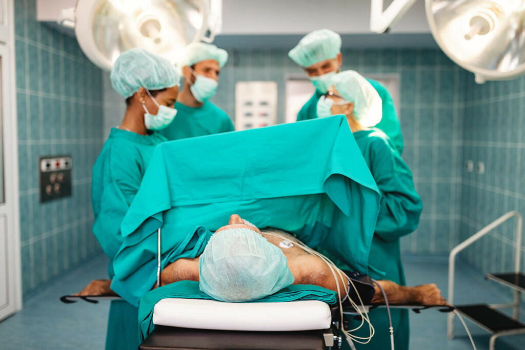 Surgical team performing a testicular prosthesis surgery