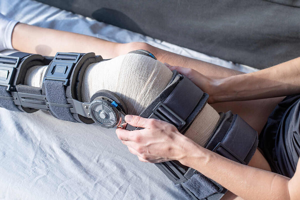 Person adjusting the Knee Ankle Foot Orthosis