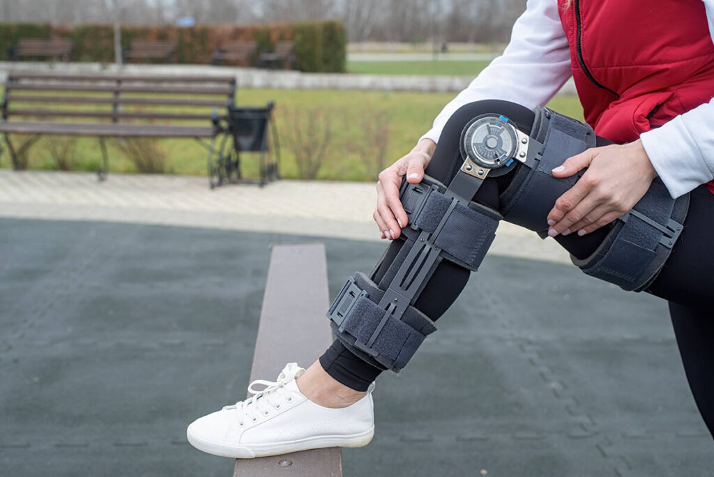 woman wearing a leg brace outside during the day