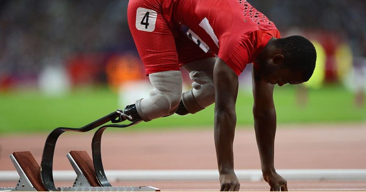 Blake Leeper, a Paralympic athlete, is seen in the starting position for a sprint race.