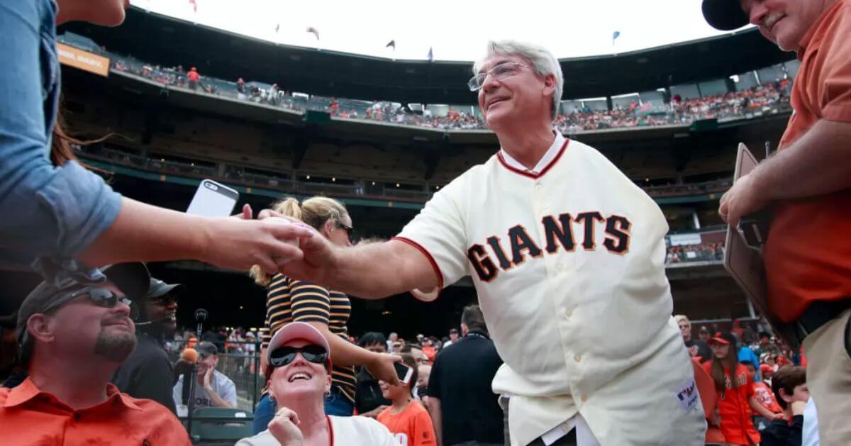 Dave Dravecky, a former Major League Baseball pitcher, is seen shaking hands with a fan at a San Francisco Giants game.