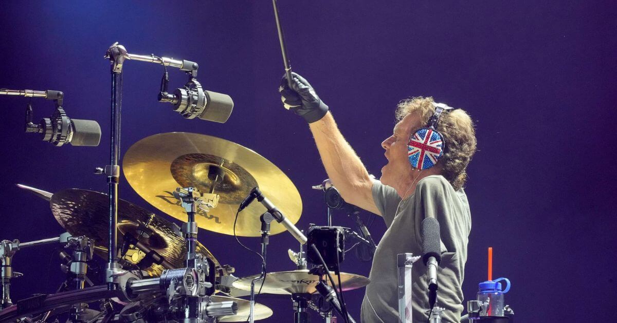 Rick Allen, drummer of Def Leppard, performing live on stage using a custom drum kit.