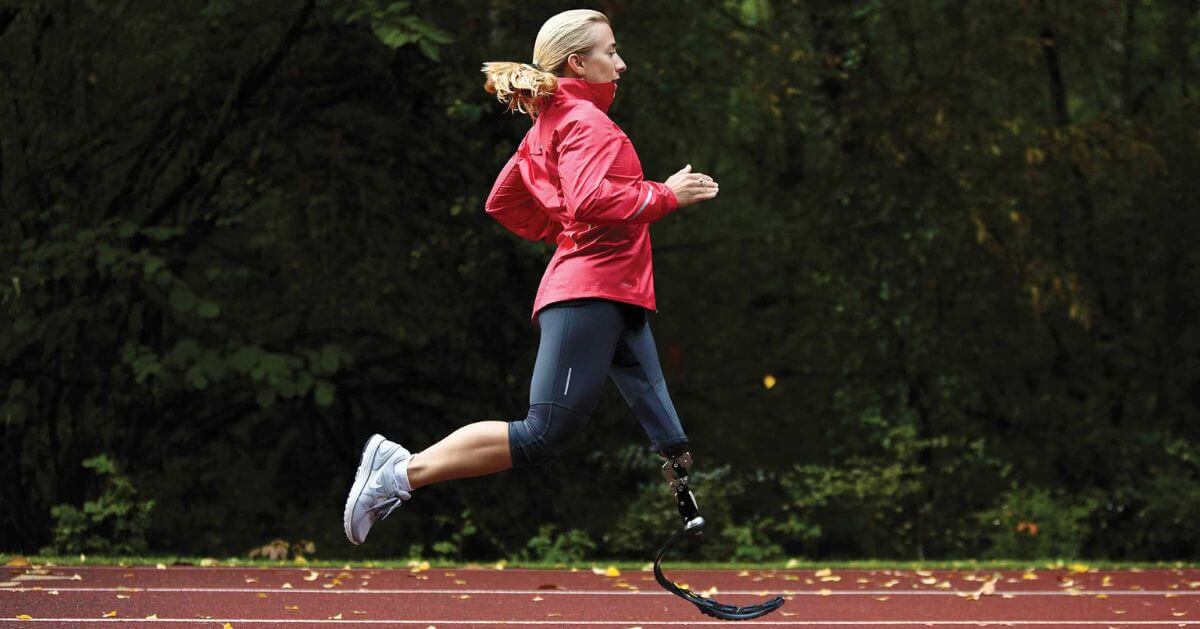 Sarah Reinertsen, a Paralympic athlete, is captured mid-run on a track.