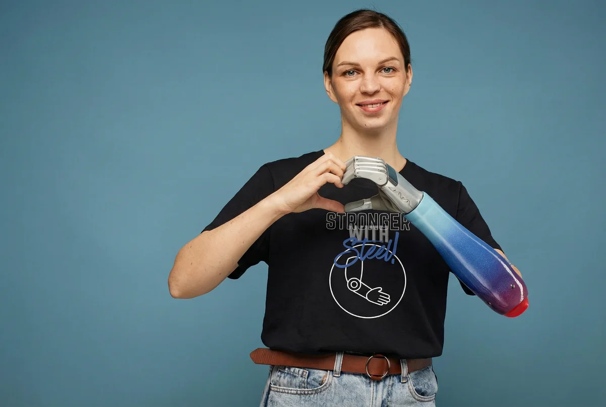 Woman making heart hands in Stronger With Steel tee