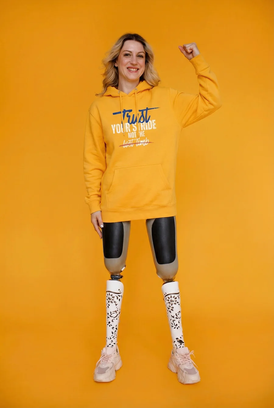 Woman celebrating in IsBrave Trust Your Stride hoodie
