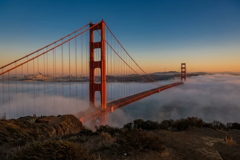 The Golden Gate Bridge in fog at golden hour with the San Francisco skyline behind, representing California amputation injury cases including the Privette doctrine