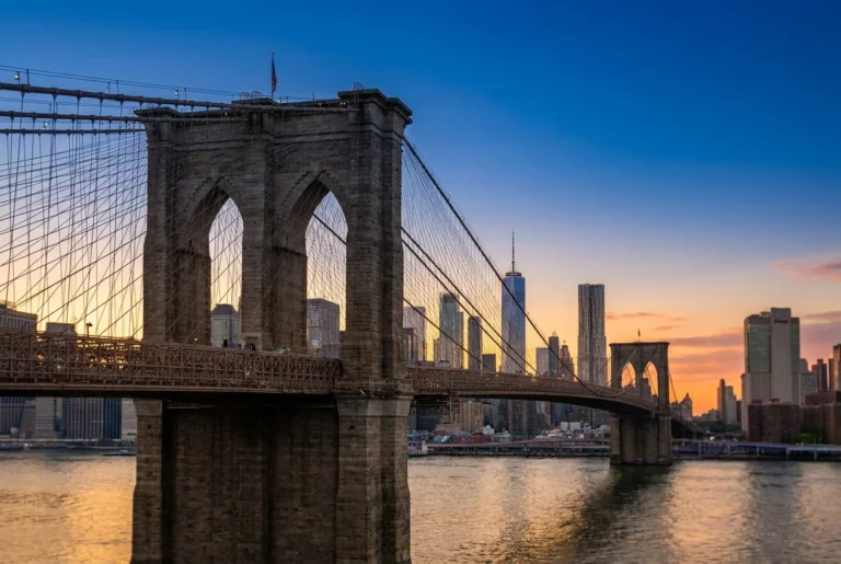 The Brooklyn Bridge with the lower Manhattan skyline at sunset, representing New York amputation injury cases including the Scaffold Law