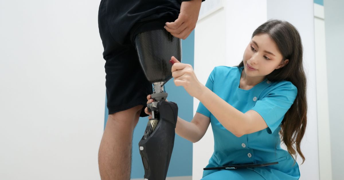 Prosthetist adjusting the fit of a below-knee prosthetic leg