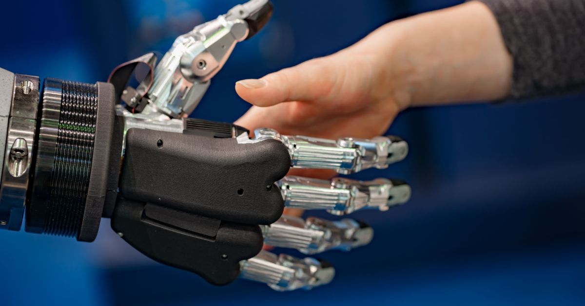 Close-up of a person touching the fingers of a myoelectric prosthetic hand