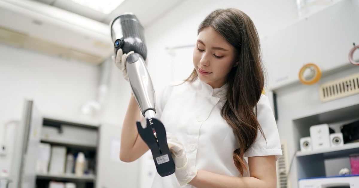 Prosthetist examining a prosthetic leg in a clinic