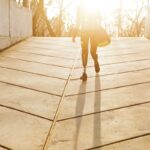 Woman with a below-knee prosthetic leg walking up an outdoor ramp